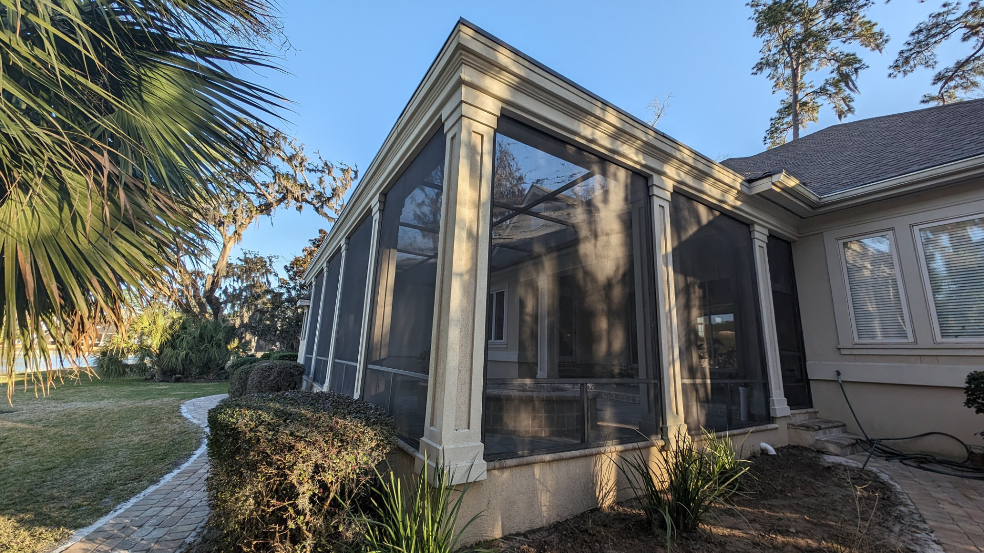 Screened Porch: White-framed porch on brick home in Beaufort, SC