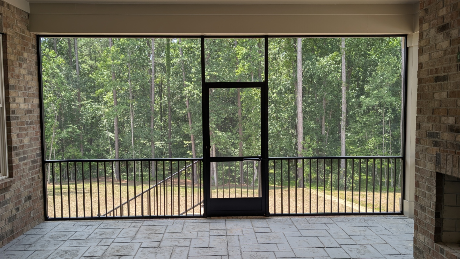 Screened Porch: Interior view with fireplace and screen door in BLUFFTON, SC